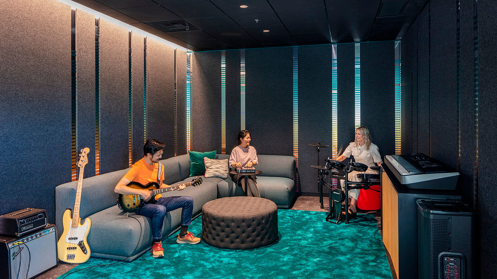 A group of people sitting on a couch with instruments.