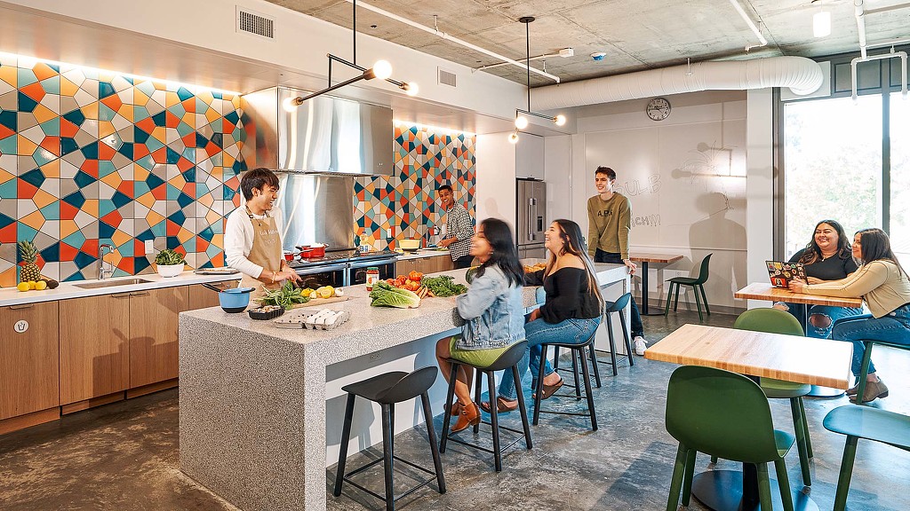 A group of people sitting at tables.