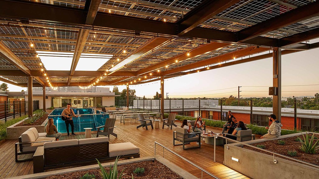 A group of people sitting on benches in a large building.