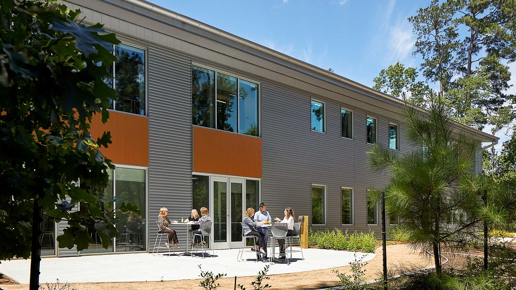 A group of people sitting outside a building.