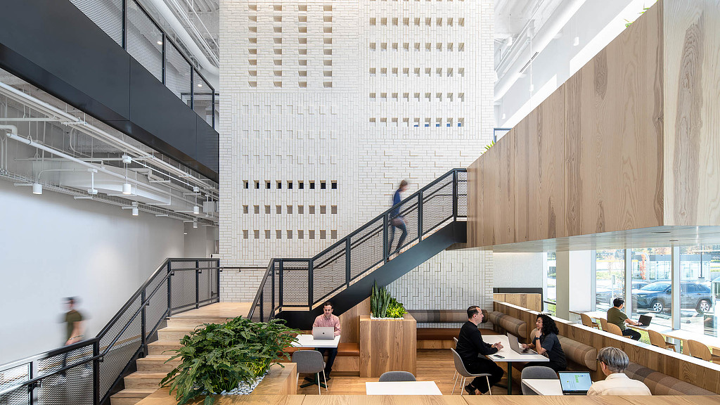 People sitting at tables in a building.