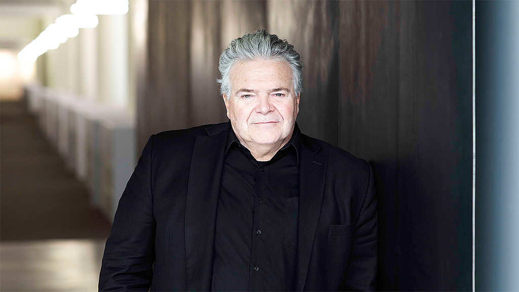 A man in a black suit.