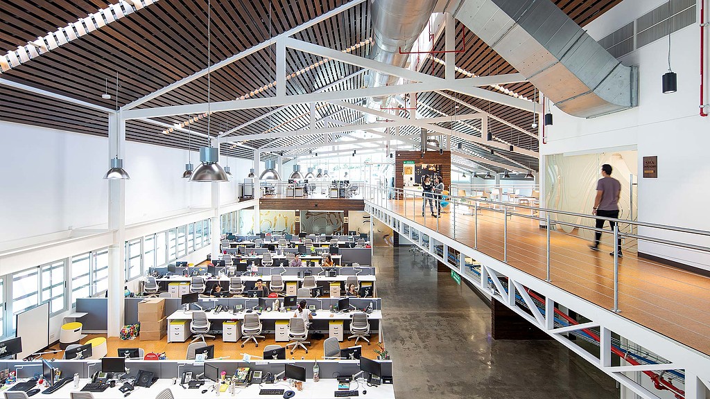 A room with people working on computers.