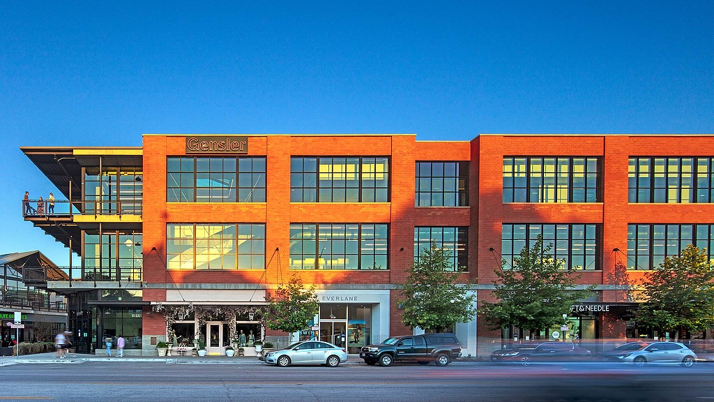 A building with cars parked in front.