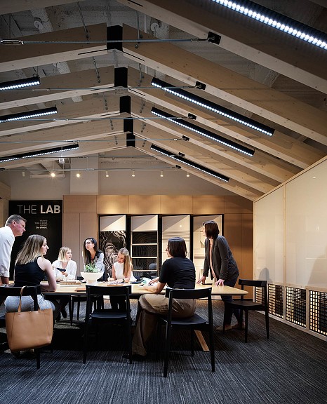 7 people gathered around meeting room table at DIRTT Dallas