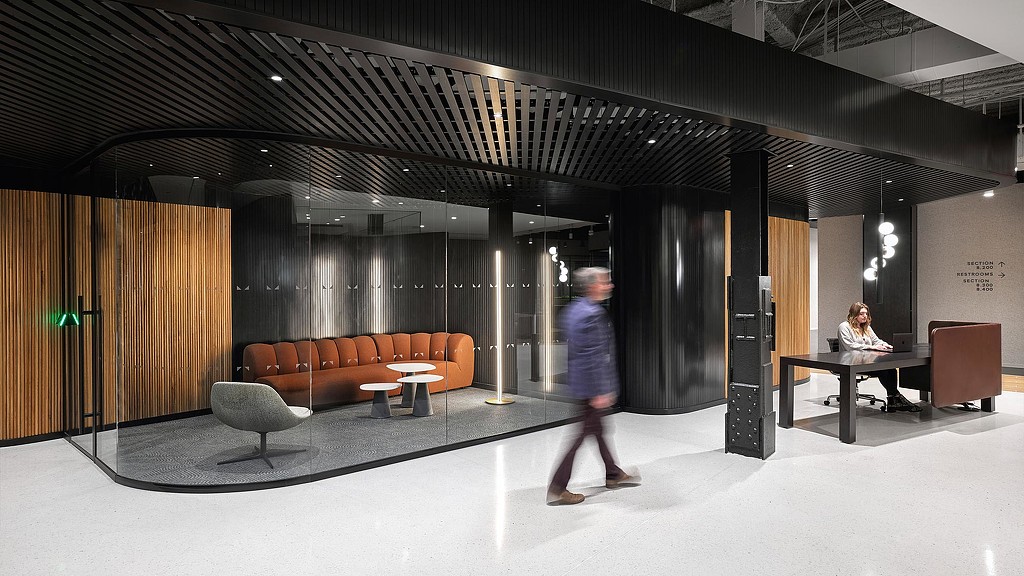 Man walking by Morning Consult headquarters meeting room