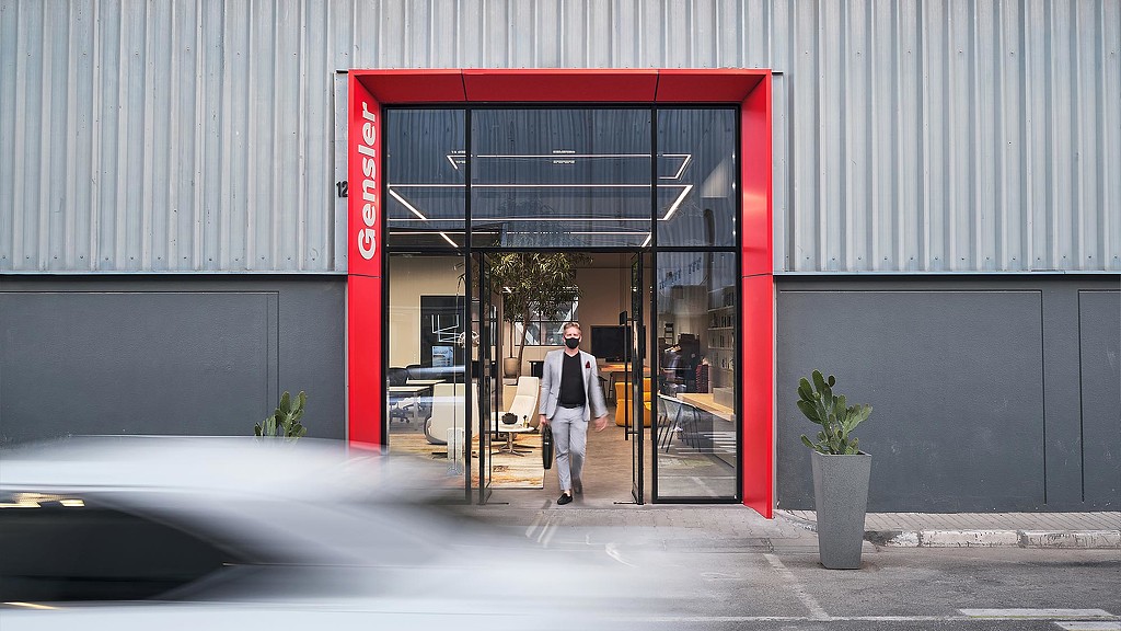 A person walking out of a building.