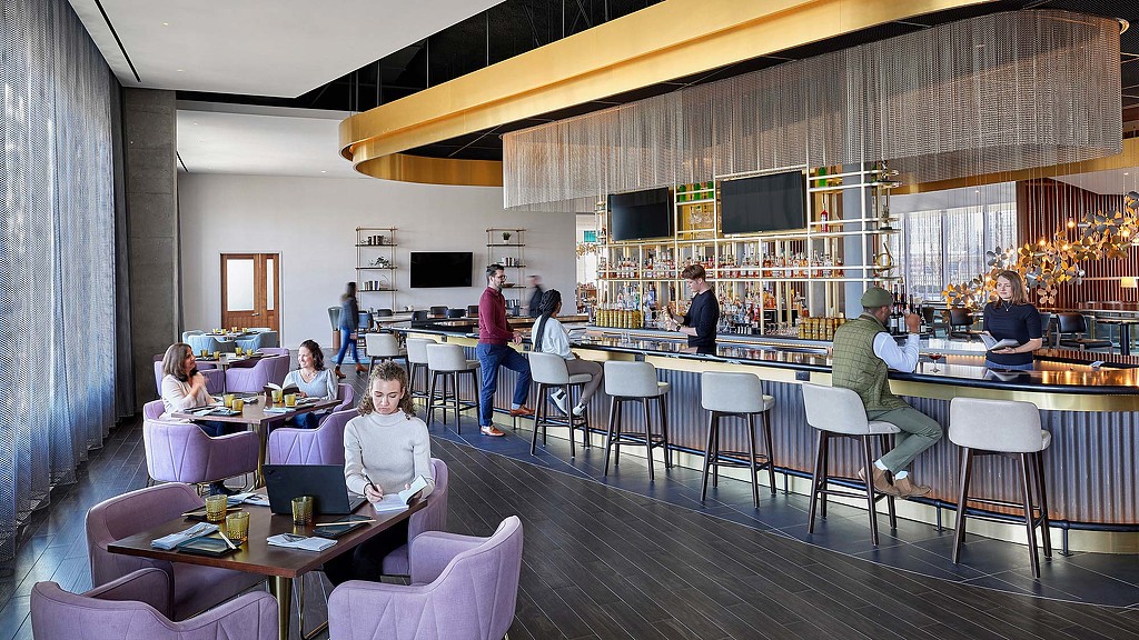 A group of people sitting at tables.