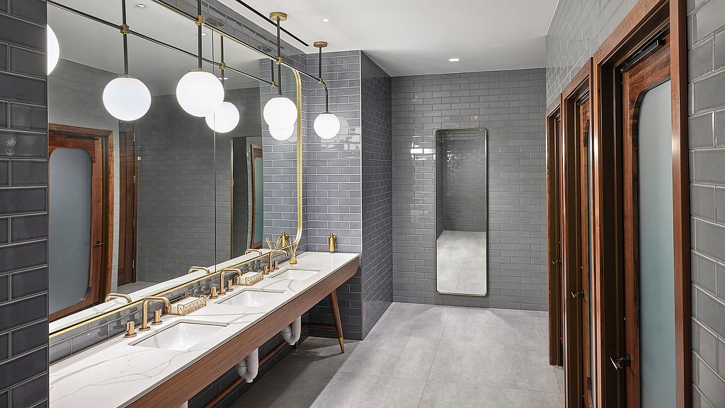 A bathroom with a large mirror.