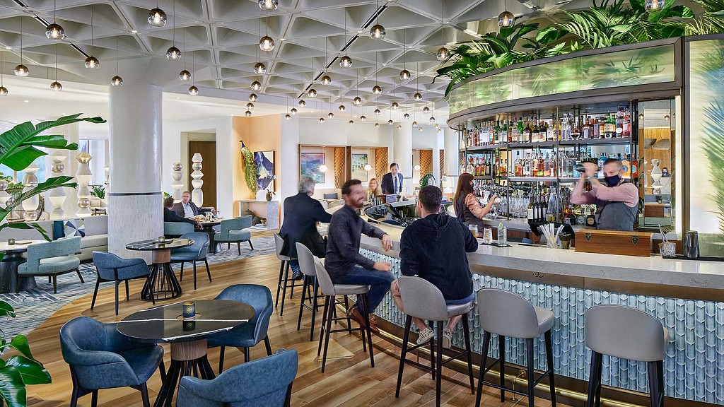 A group of people sitting at a bar.
