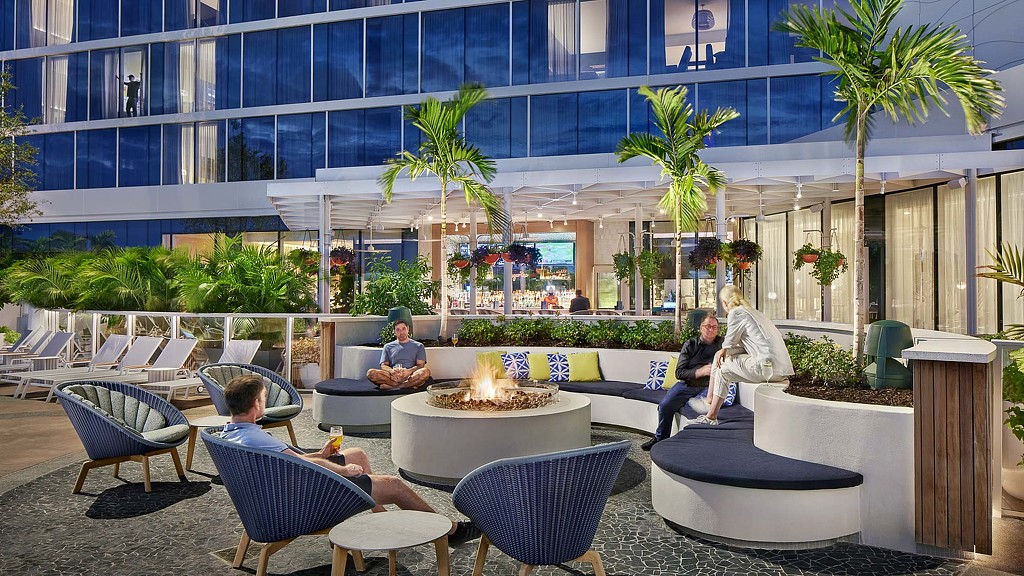 A group of people sitting in chairs outside a building.
