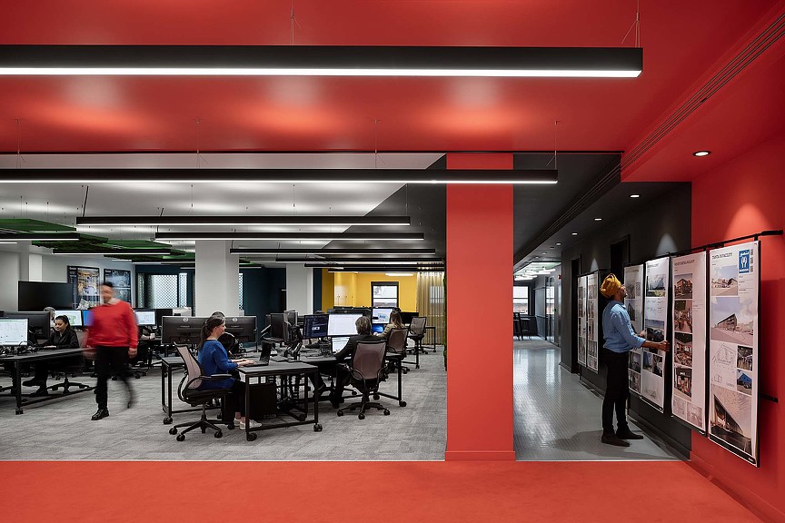 People in a room with tables and chairs.