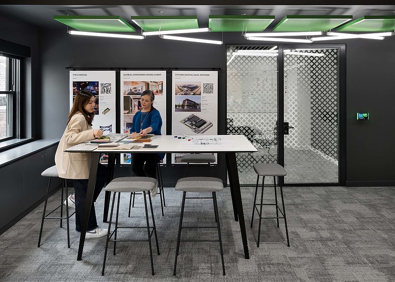 A man and woman sitting at a table with a menu.