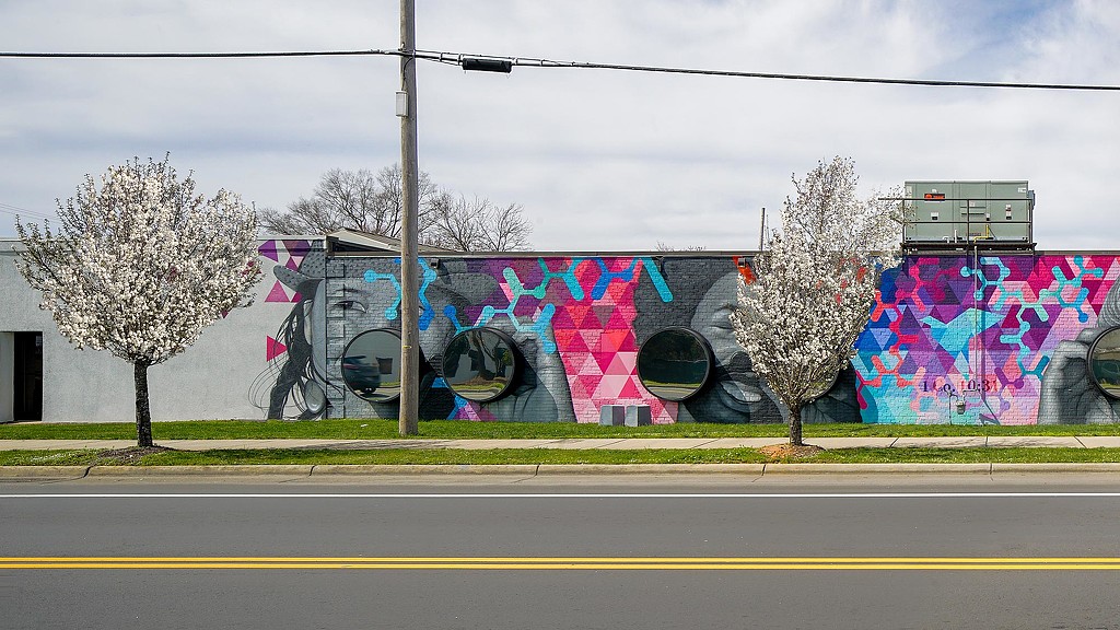 CBI Art Wall public mural of faces with 3D binoculars