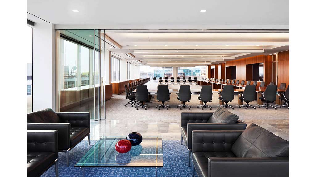 A large room with a pool table and chairs.