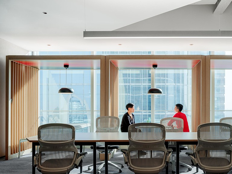 2 women sitting in CBRE Beijing office meeting room booth