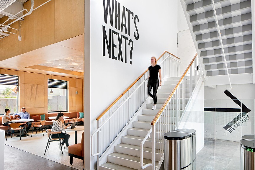 Confidential energy client headquarters staircase with What's Next wall graphic