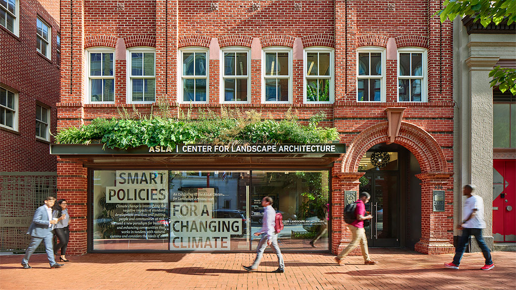 People walking past a building.