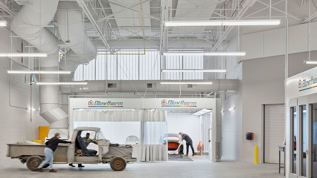 A group of people working in a large room.