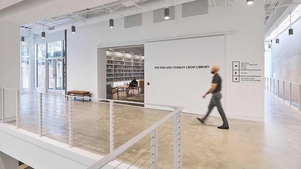 A man walking by The Tom and Charley Crow Library at First Unitarian.