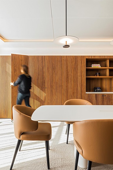 Woman opening closet door in conference room.
