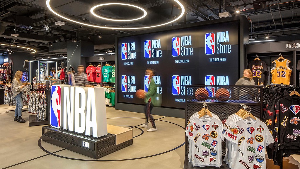 NBA Store Berlin interior with sign and digital screen.