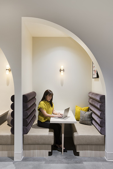 A person sitting at a table with a laptop.