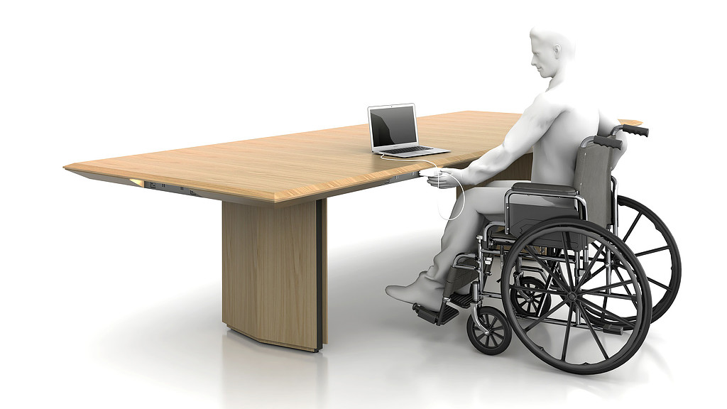 A person in a wheelchair working on a laptop.