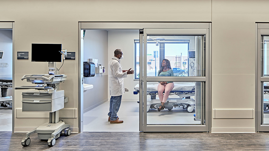 Doctor with patient in Henry Ford Health System Plymouth Medical Office Building room.