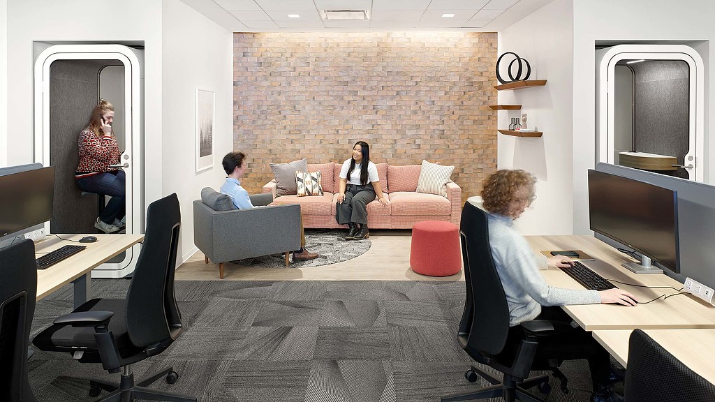 Workstations adjacent to open collaboration space and closed focus booth