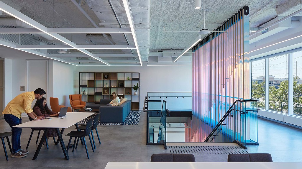 Open collaboration space next to interconnecting staircase