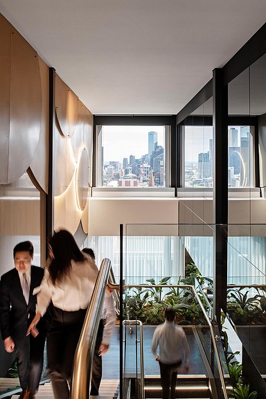 Workers walking up the staircase at professional services firm office