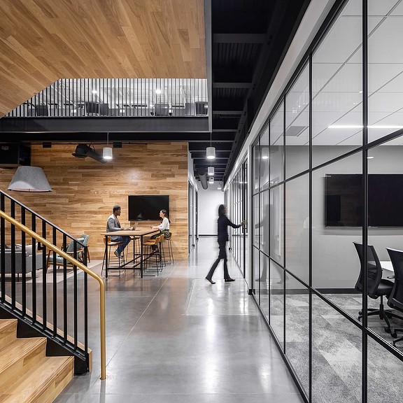 A wooden stair case and focus conference room at Loffler Companies