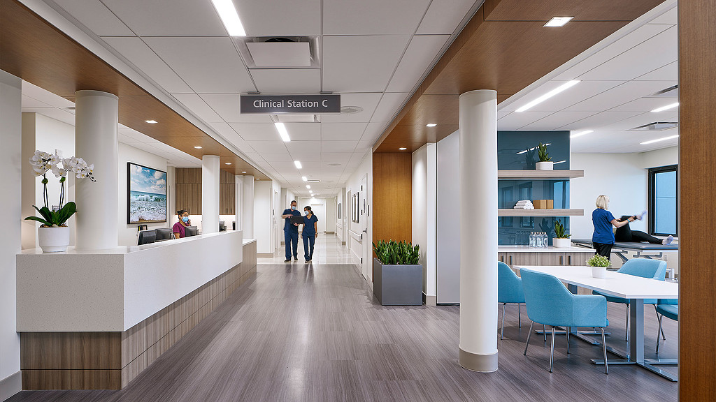 Acute rehabilitation center hallway with reception on left and clinical station on right