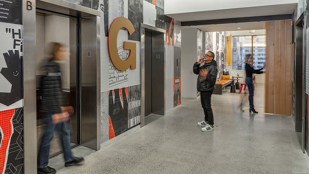 A group of people standing in a hallway.
