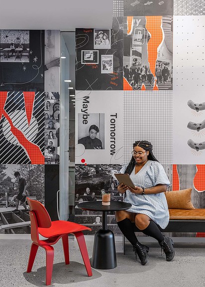 A person sitting on a couch reading a book.
