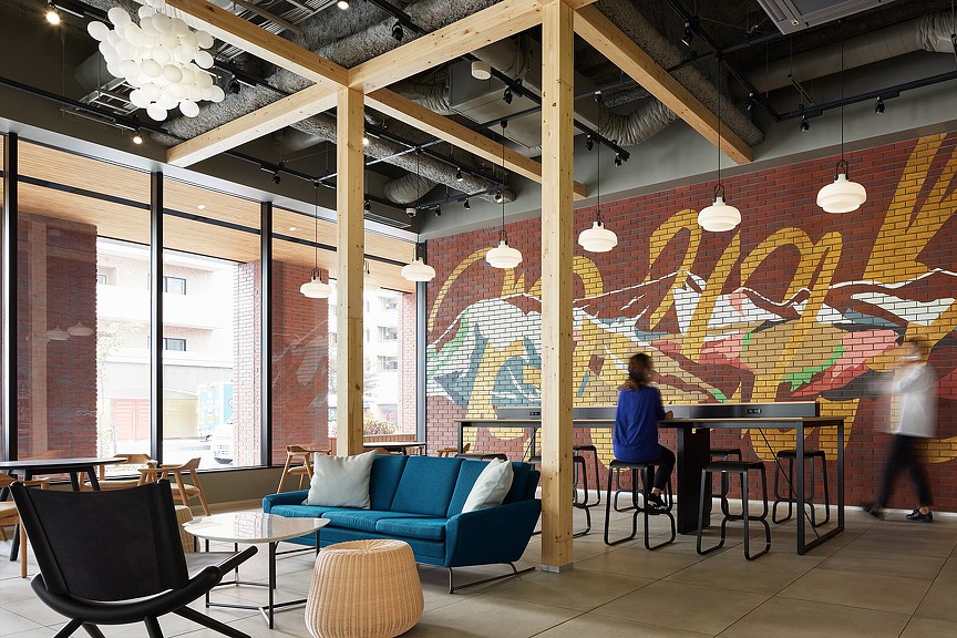 The Peak Sapporo workplace lounge with brick wall art