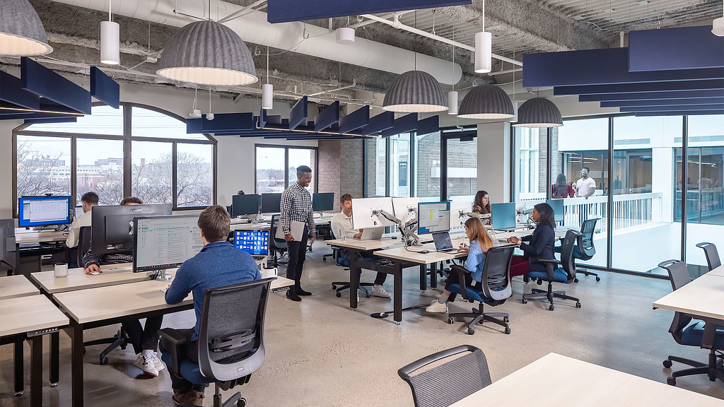 A collaborative work space indoors with acoustic ceiling panels