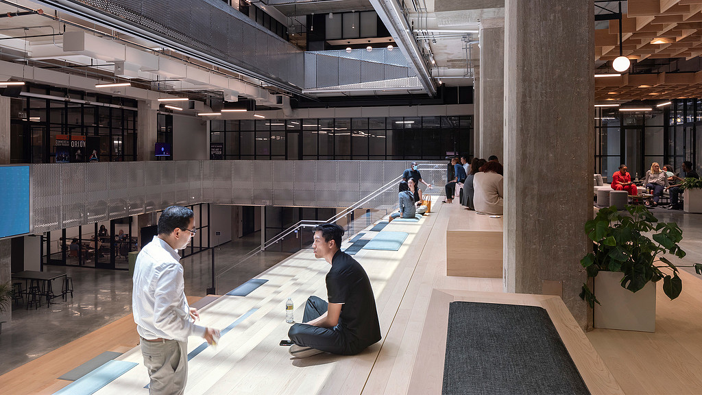 People conversing on the steps inside the Ion