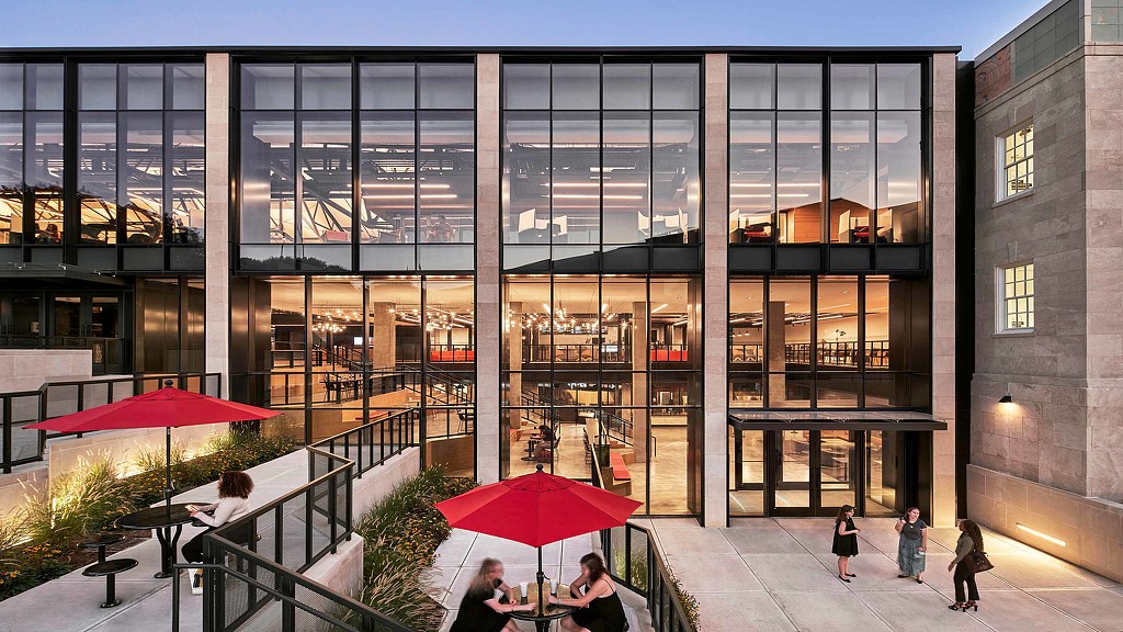 The glass facade and leveled outdoor seating areas at Kentucky University Commons Helm Library