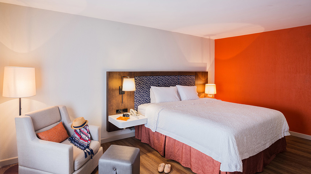 Hampton Inn Alajuela bedroom with sofa chair and lamps