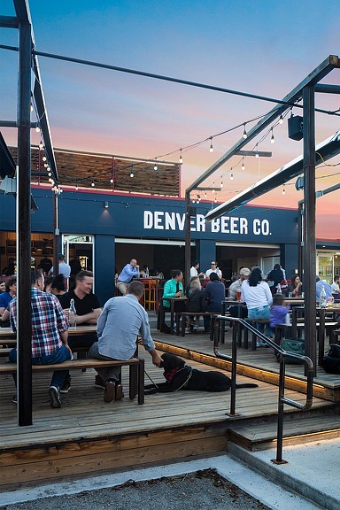 People hanging out at Denver Beer Co outdoor patio with dog