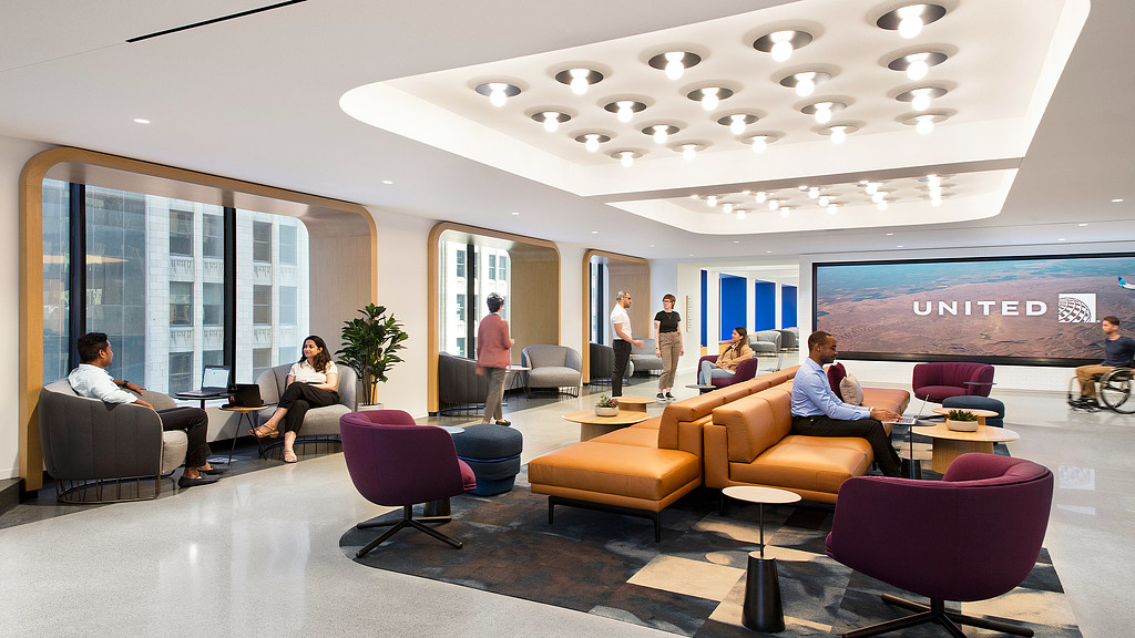 A lightweight lobby area with an accent ceiling at United Airlines lounge