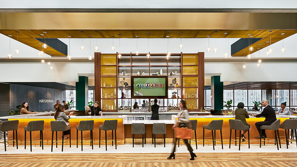 A gold bar at Voco Holiday Inn with a tv in the middle