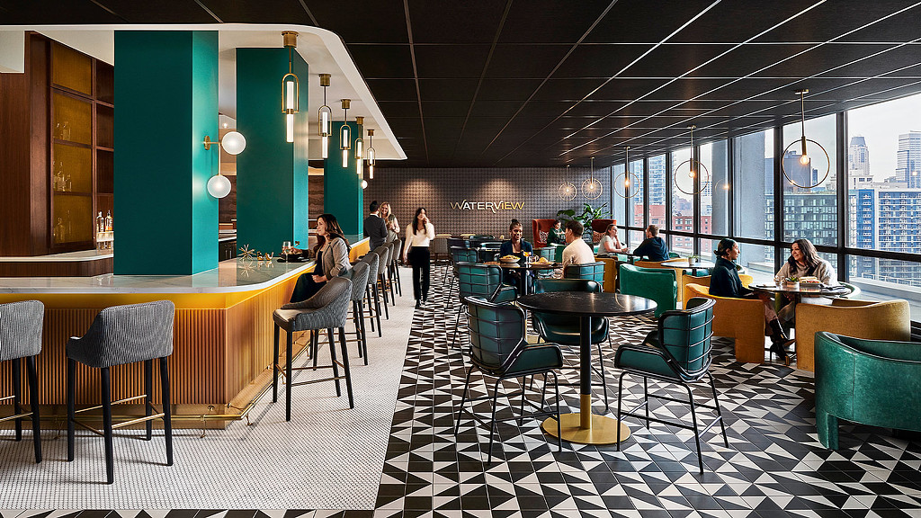 A green bar and cafe seating area at Voco Holiday Inn