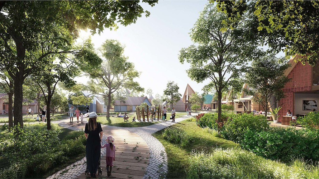 A woman and a child walking on a path in a park.