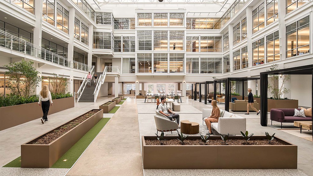 A building with a few people and a few people walking around.