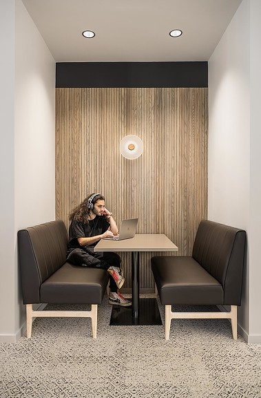 A person sitting at a table with a laptop.