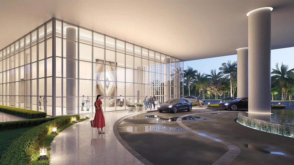 A person in a red dress standing in front of a building.