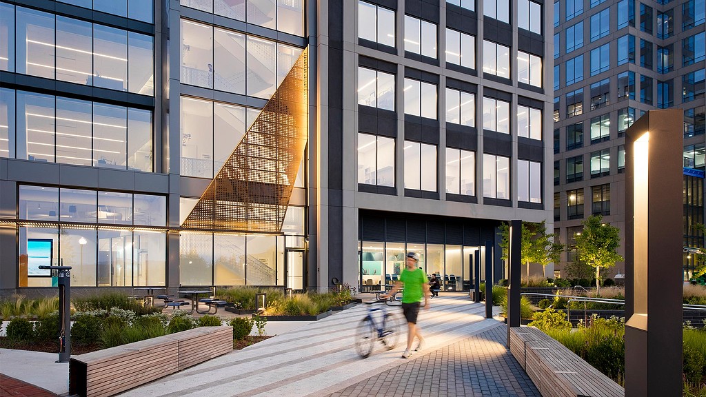 A person walking with a bicycle.